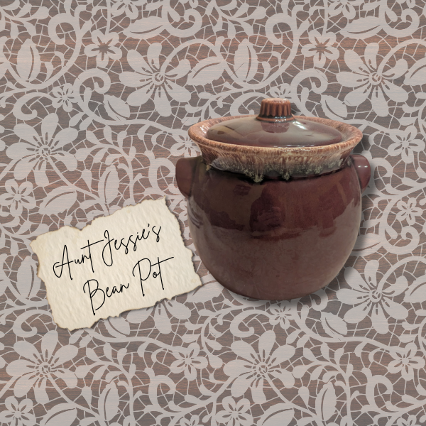 Mid-century Hull Pottery bean pot with label reading ‘Aunt Jessie’s Bean Pot’ on a lace background.